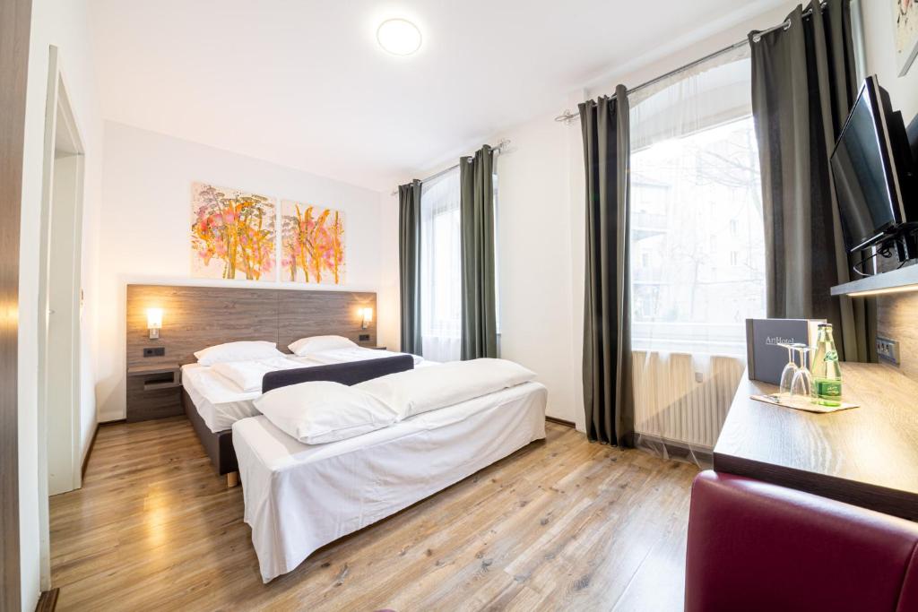 Postel nebo postele na pokoji v ubytování ArtHotel City