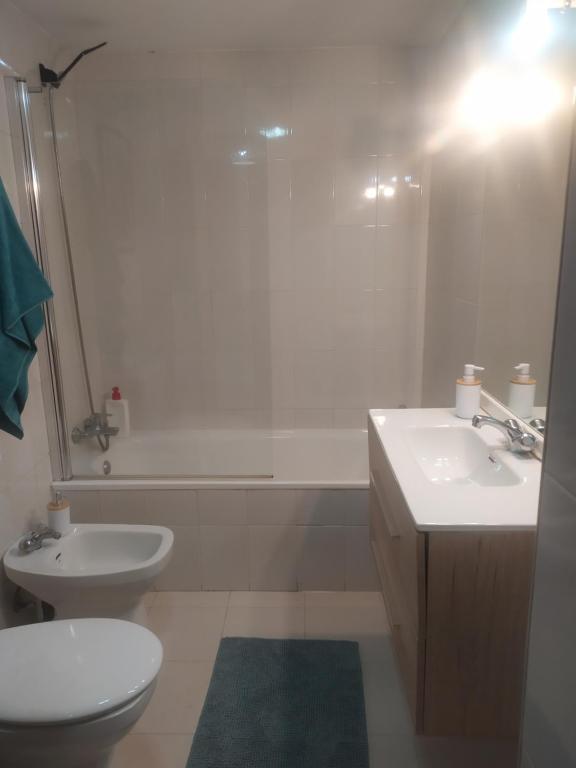 a white bathroom with a toilet and a sink at TXIMELETA Haro in Haro