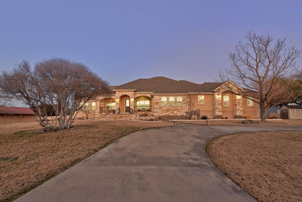 a house with a driveway in front of it at Spacious House in Roundrock in Round Rock