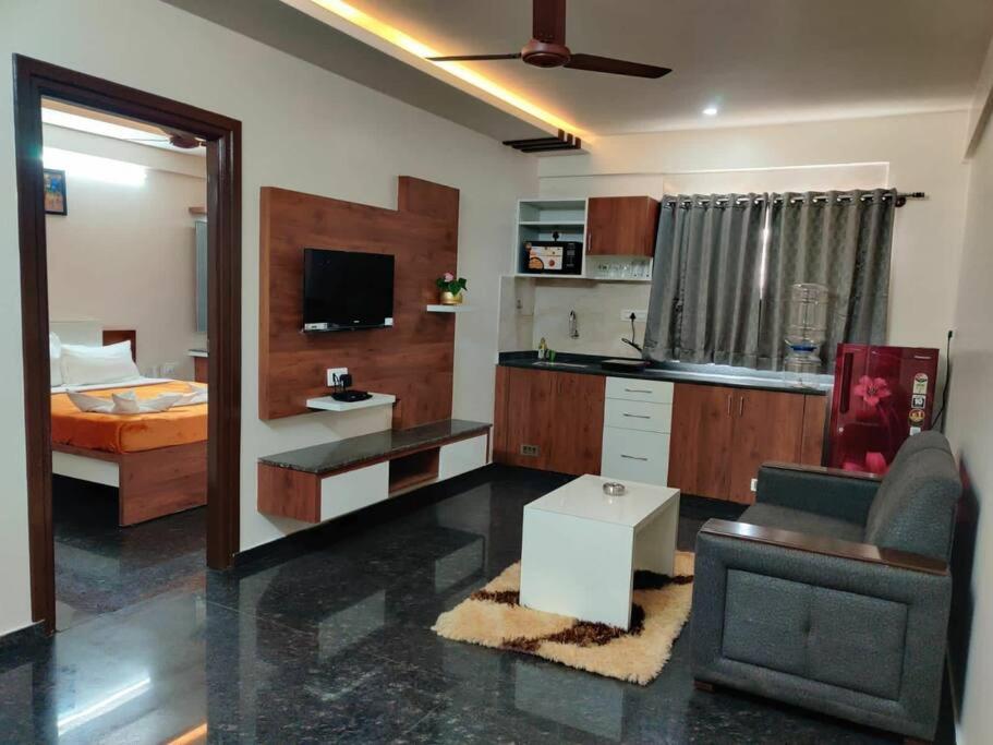 a living room with a couch and a bed at 11. 101@HSR Premium Fully Furnished 1BHK Flat in Bangalore