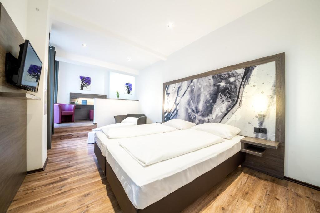 Postel nebo postele na pokoji v ubytování ArtHotel City