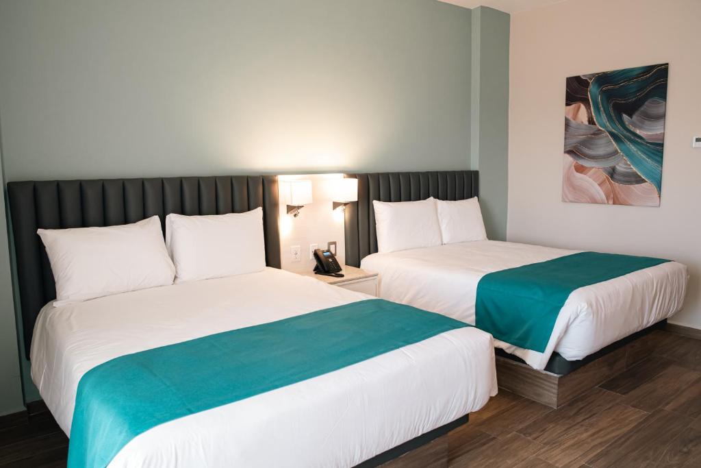 Postel nebo postele na pokoji v ubytování HIGH GARDEN GRAND HOTEL