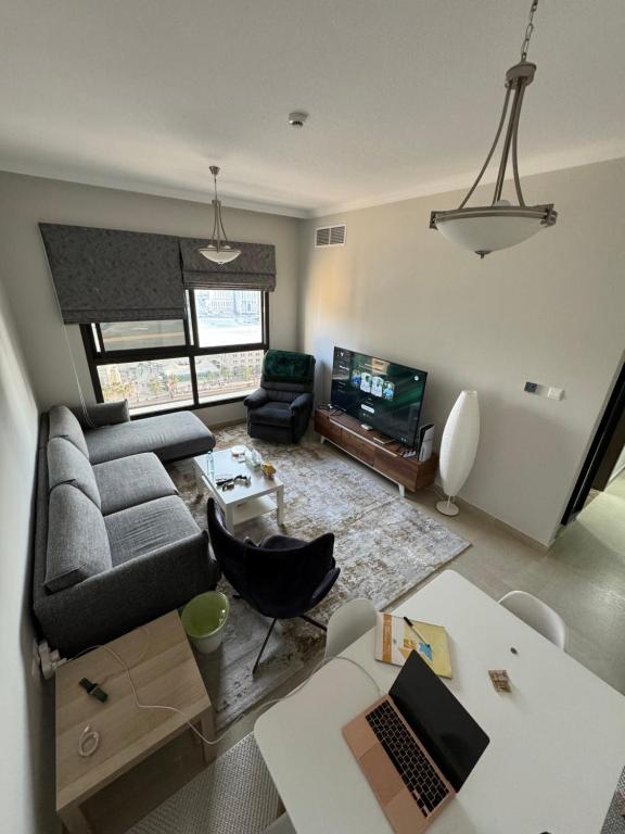 a living room with a couch and a tv at sharja 1103 in Sharjah
