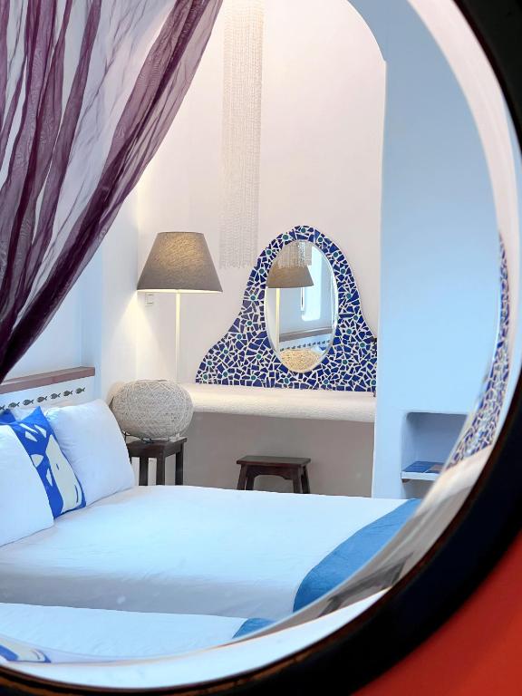 a bedroom with a bed and a mirror at Greek Frontier Villa in Magong