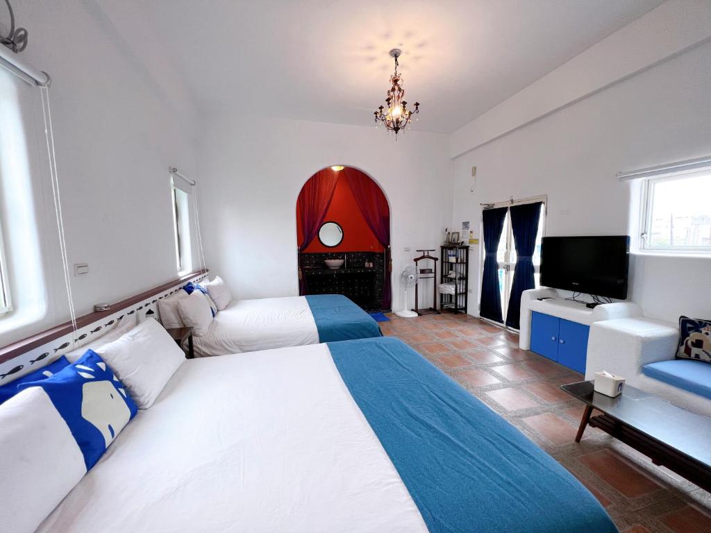 a bedroom with a large bed and a fireplace at Greek Frontier Villa in Magong