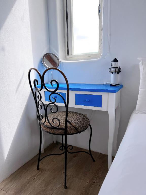 a chair sitting next to a desk with a window at Greek Frontier Villa in Magong