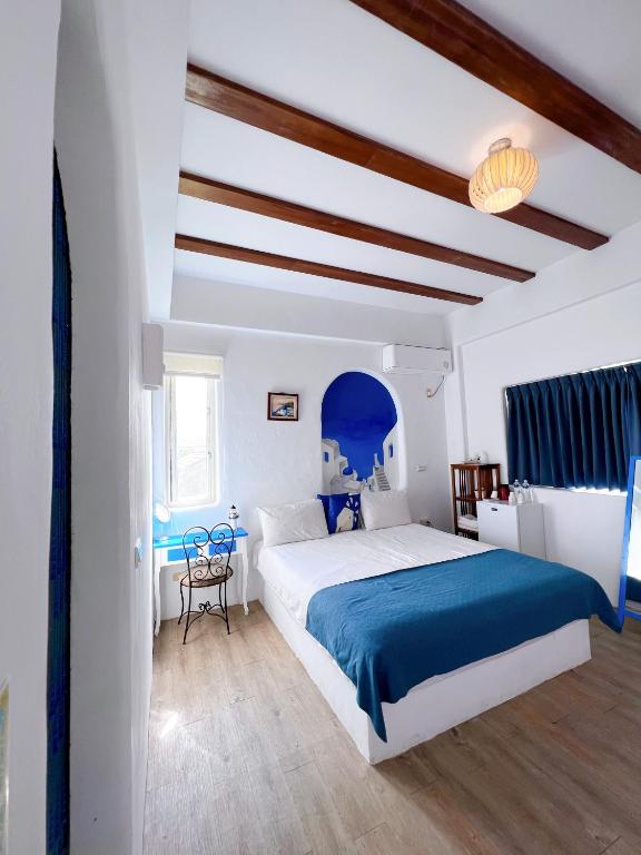 a bedroom with a large bed and a blue ceiling at Greek Frontier Villa in Magong