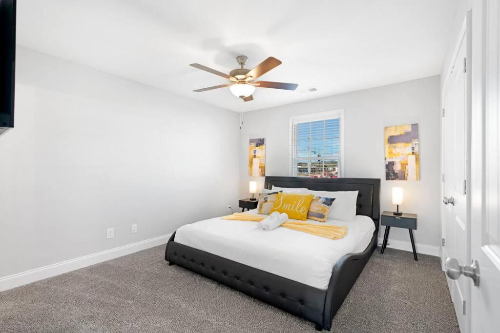 a bedroom with a bed with a ceiling fan at Make Lemonade in luxury w king bed and free parking plus 40 minutes to Nashville in Clarksville