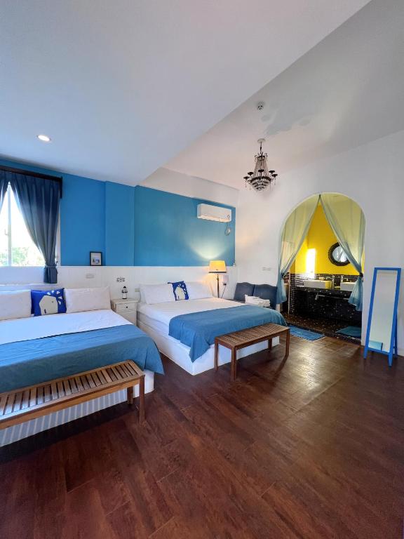 a hotel room with two beds and a fireplace at Greek Frontier Villa in Magong