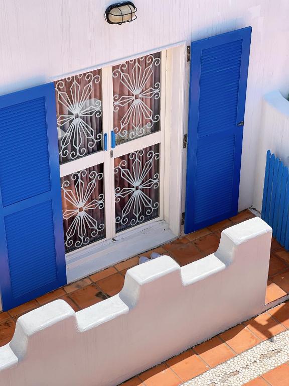 a room with two blue doors and a window at Greek Frontier Villa in Magong