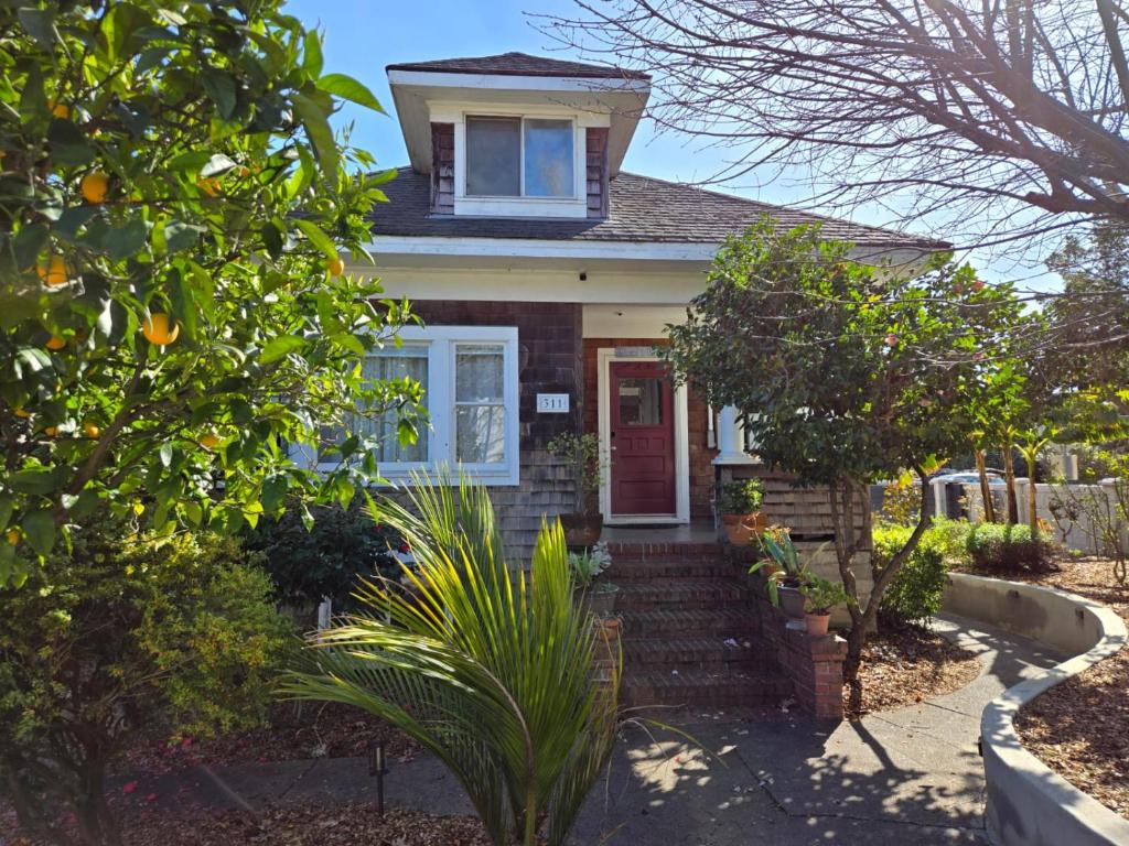 a house with a red door and some plants at Beautiful Spacious Victorian Garden Oasis Central, Gated, Deck, BBQ in San Rafael