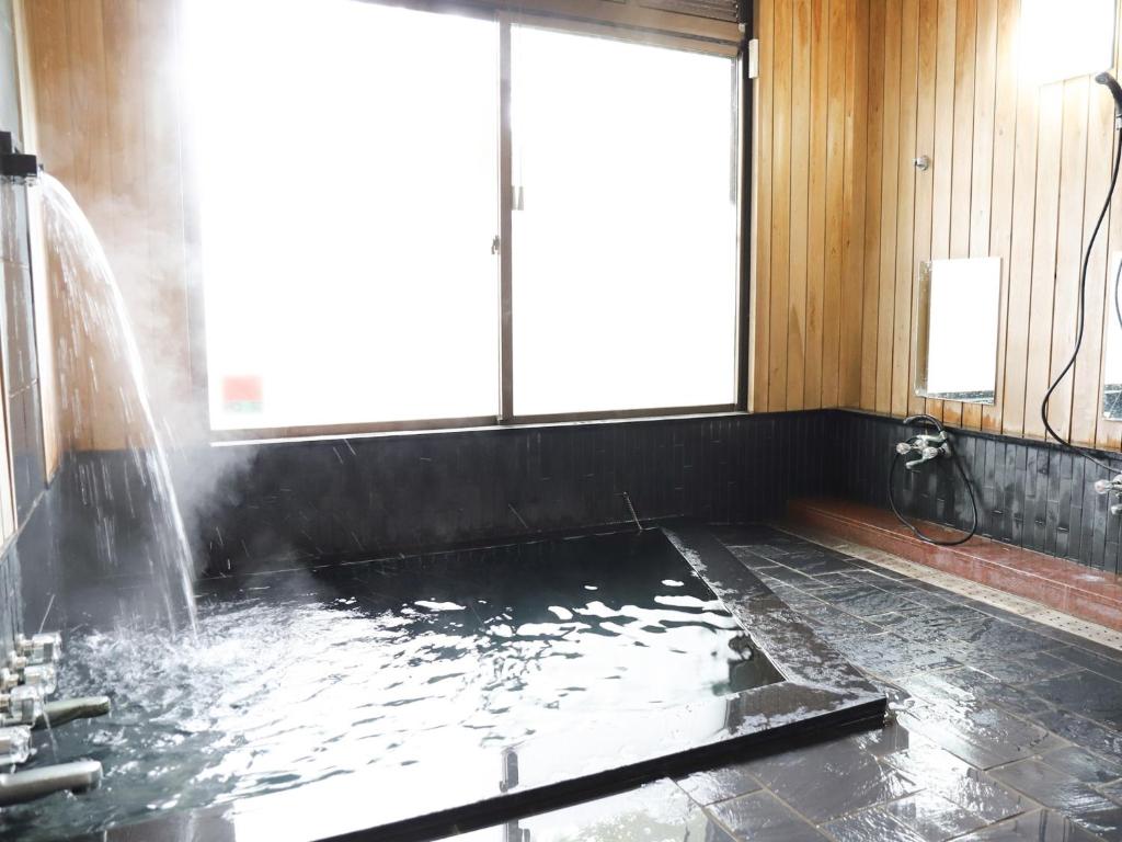 a bathroom with a tub with a water fountain at Miraisou - Vacation STAY 15695 in Kirishima