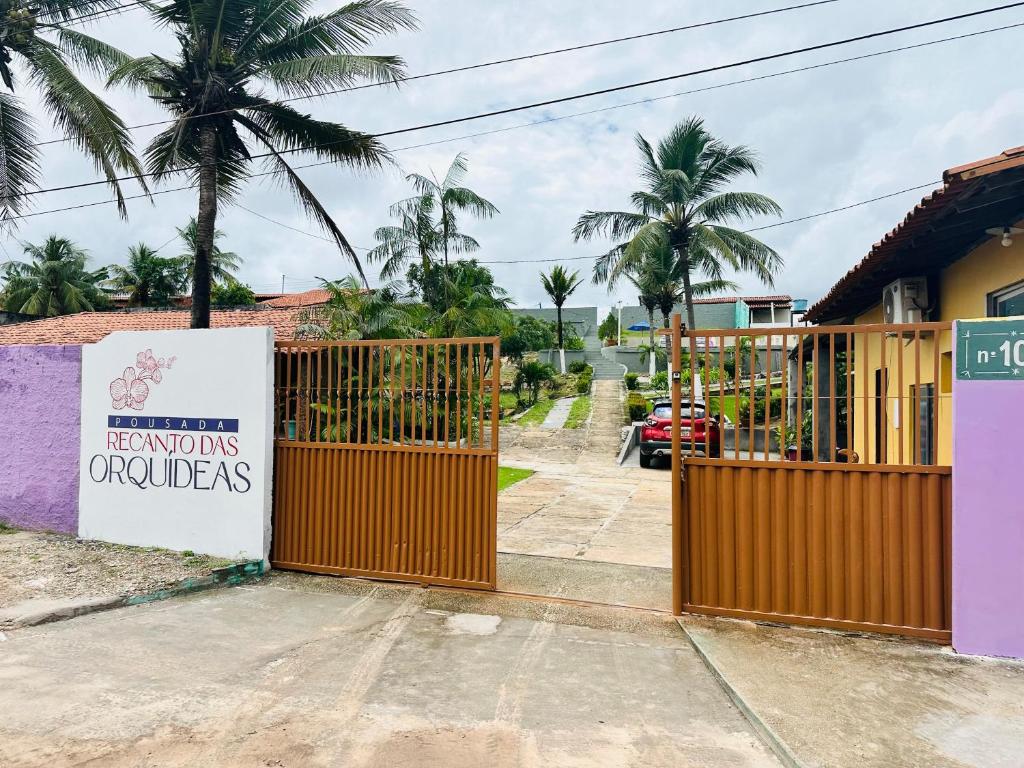 ein Tor mit einem Schild vor einem Haus in der Unterkunft Pousada Recanto das Orquídeas in Barreirinhas