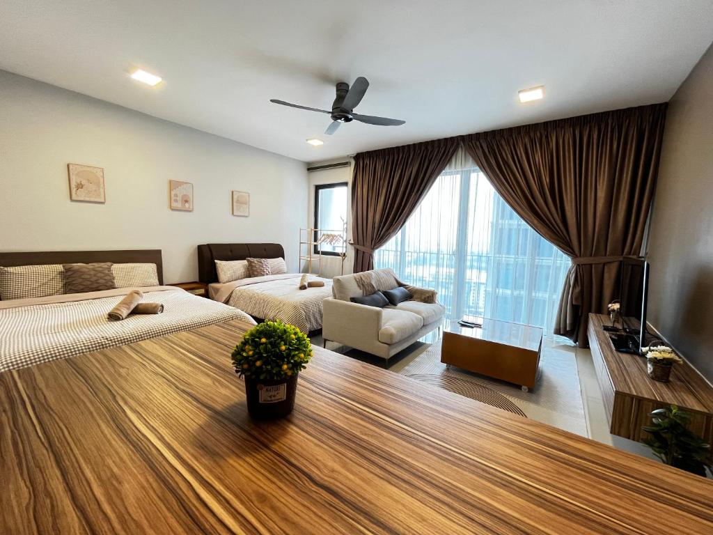 a large bedroom with two beds and a couch at 1-5 Pax Comfy Trefoil Studio-Walk to Setia City Mall & Setia City Convention Centre in Shah Alam