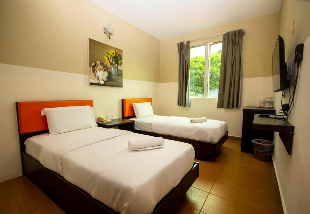Postel nebo postele na pokoji v ubytování JQ Suria Hotel