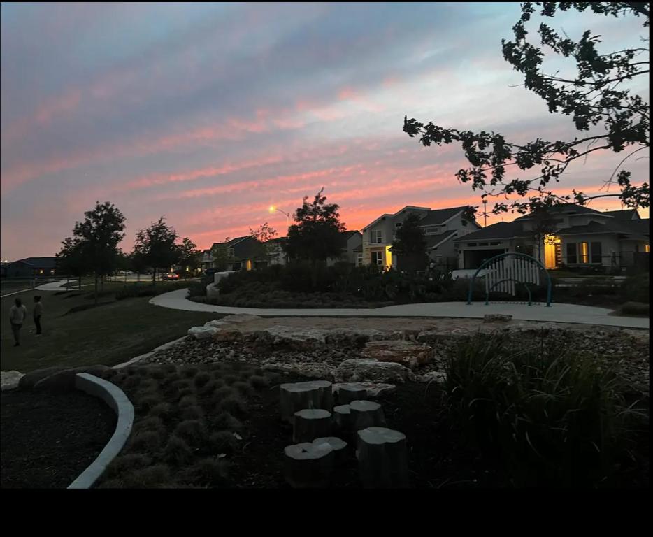 a sunset in a residential neighborhood with a house at Banty Villa - Master Lounge in Austin