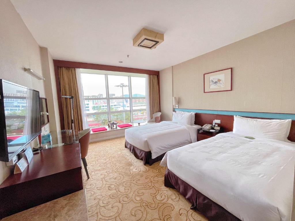 Postel nebo postele na pokoji v ubytování Liuhua Hotel