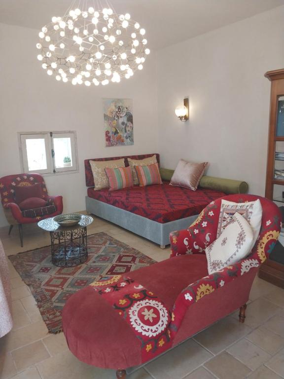 a living room with a bed and a couch at Luxury studio at the heart of old Jaffa in Tel Aviv