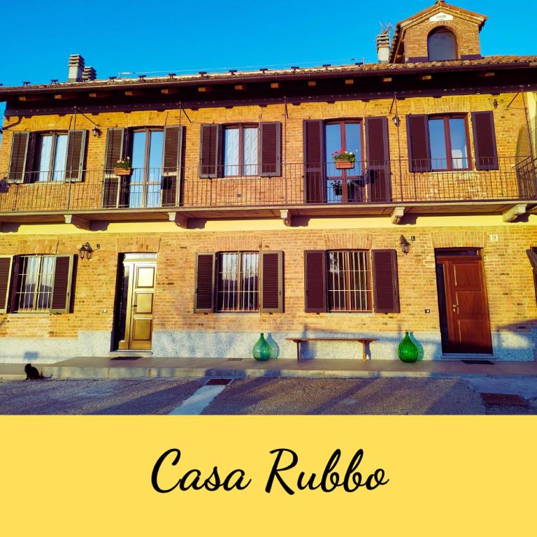 an old building with a bench in front of it at Casa Rubbo - Appartamento in collina 'Monviso' in Alba