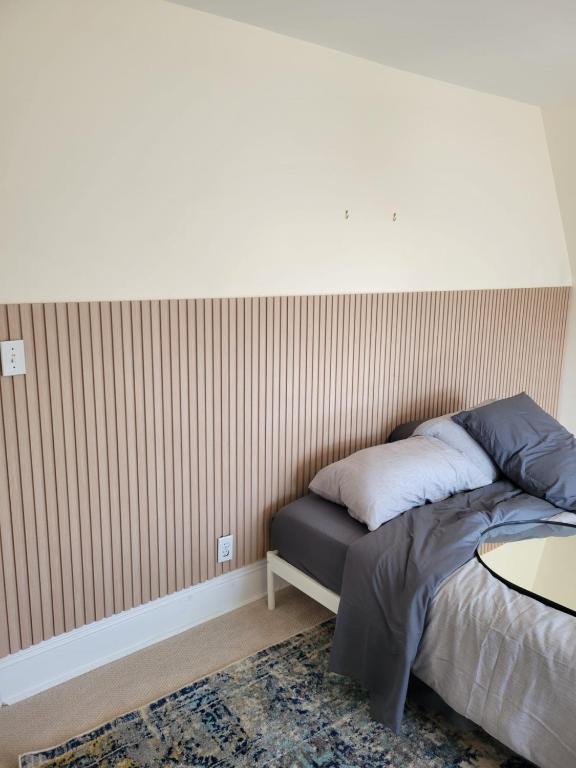 a bedroom with a bed and a table in it at Ottawa Downtown Cozy Guesthouse in Ottawa