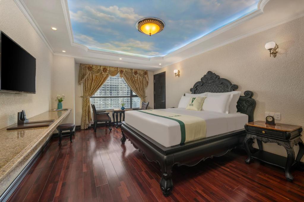 Postel nebo postele na pokoji v ubytování V-Hotel Da Nang Beach