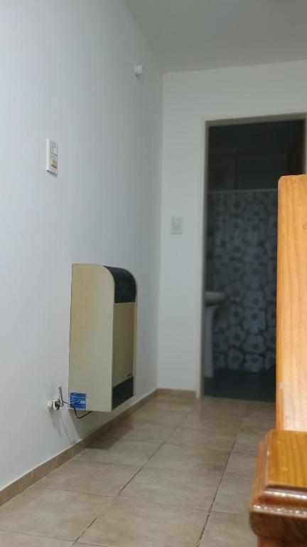 a television sitting on a wall in a room at House Las Heras in Las Heras