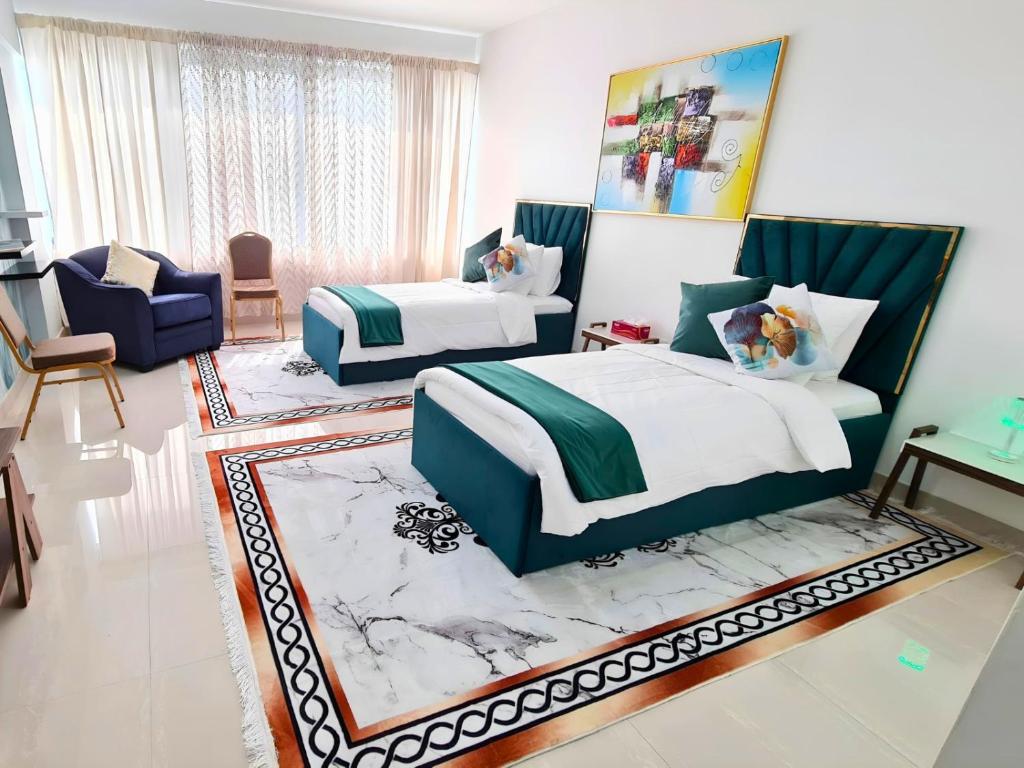 a bedroom with two beds and a living room at Gardenia Townhouse in Dubai