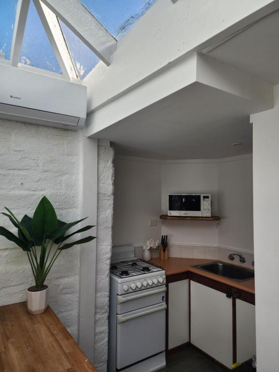 a kitchen with a white stove and a sink at Daylesford - FROG HOLLOW ESTATE - One bedroom Homestead Villa - book for 3 nights pay for 2 - contact us for more details in Daylesford