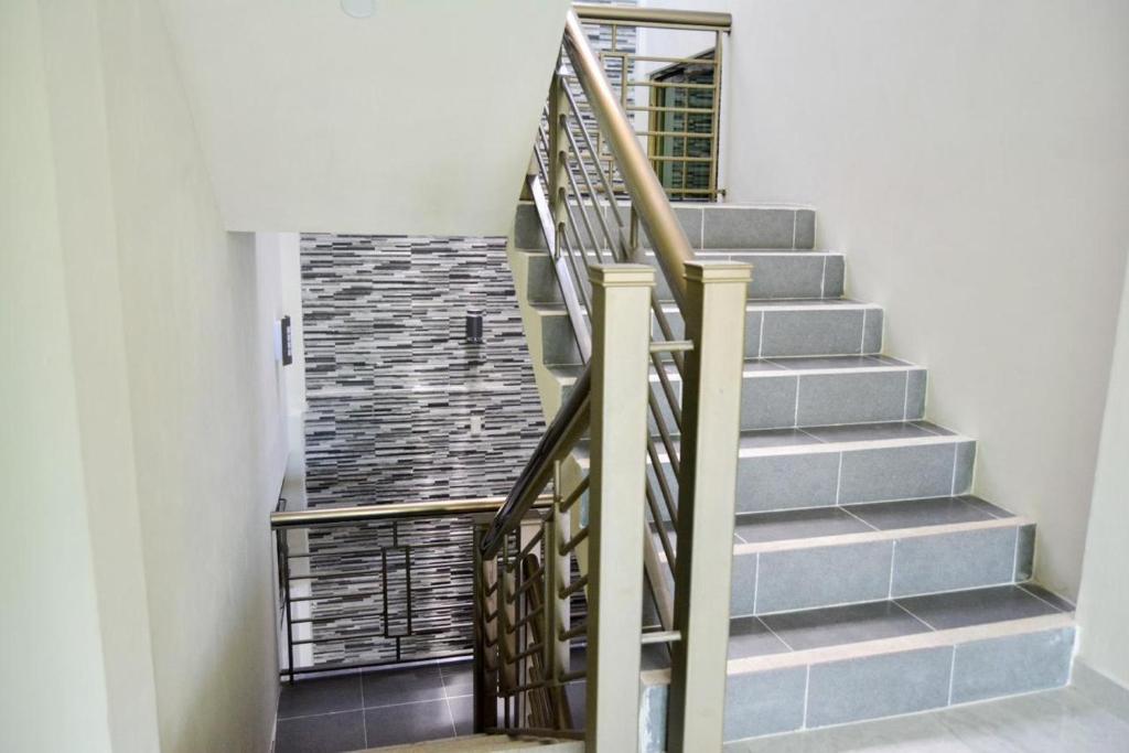 a staircase with a metal railing in a house at Hotel BEMAR in La Trinitaria