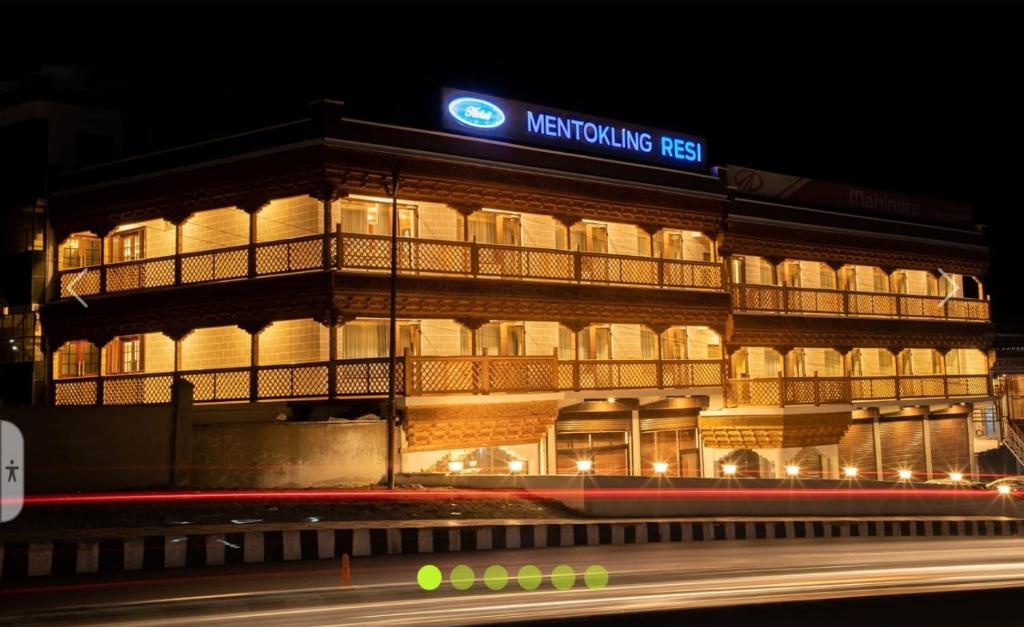 a night view of a building with a sign on it at Mentokling Residency, Leh, Ladakh in Leh