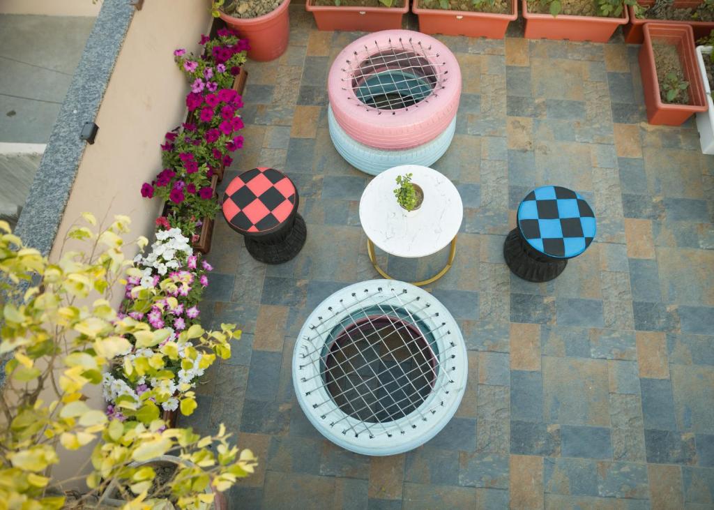 an overhead view of a patio with tables and flowers at Cozy 1bhk with Terrace. in Lucknow