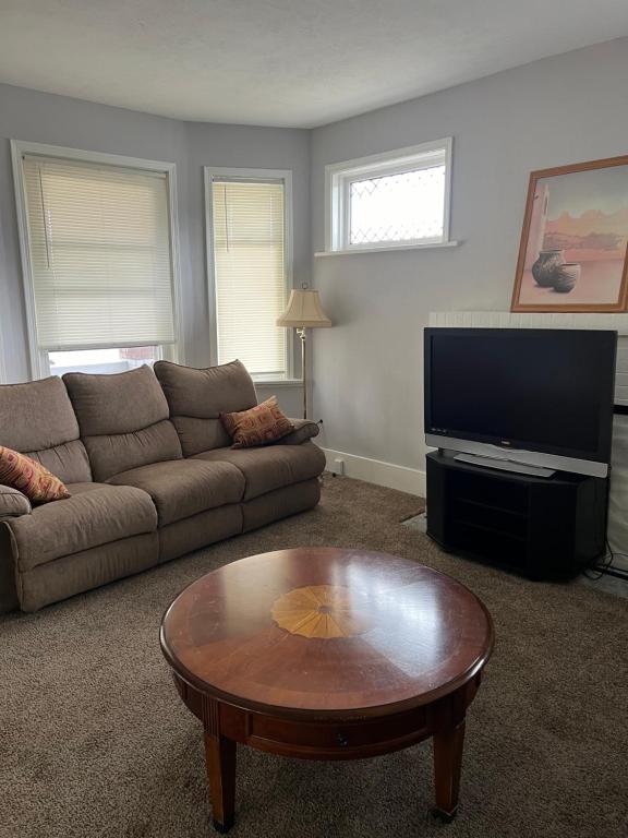 a living room with a couch and a coffee table at Shared 4 Bedroom House in South Bend
