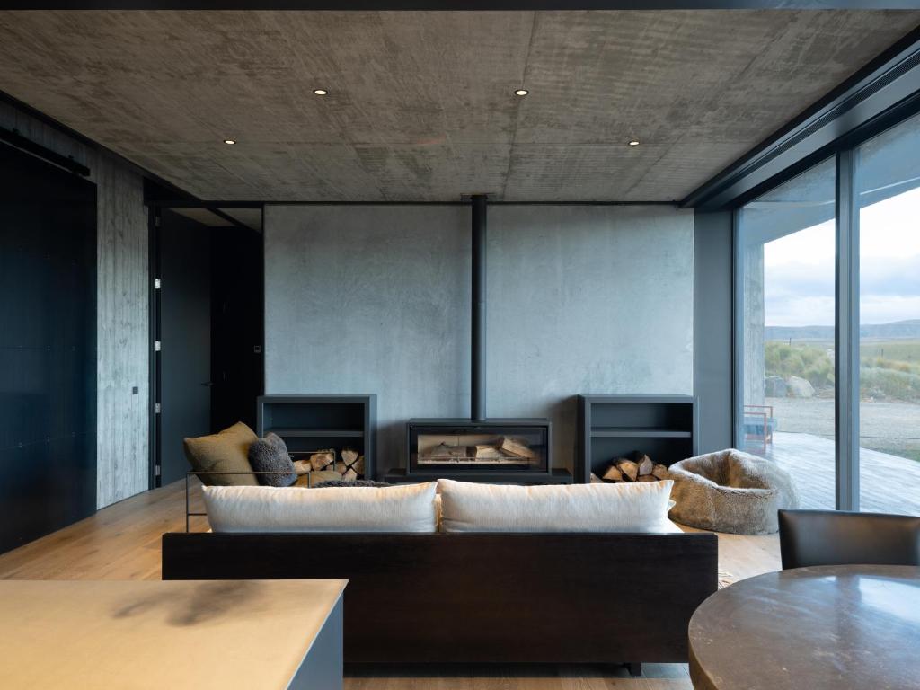 a living room with a couch and a fireplace at Bunker House in Lake Tekapo