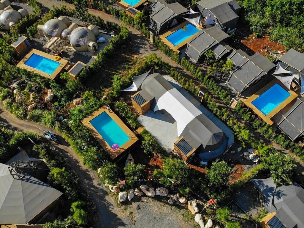 an overhead view of a resort with swimming pools at The X10 Glamping Pool Villa Khaoyai เขาใหญ่ - SHA Certified in Pak Chong