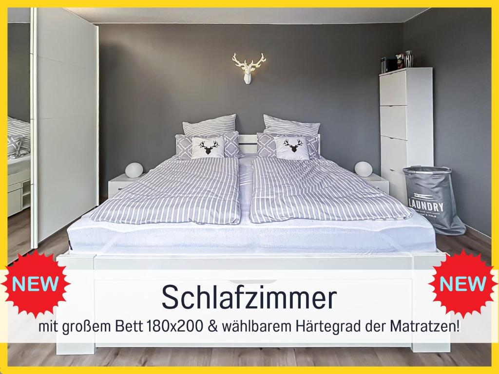 a bedroom with a white bed with pillows at HaFe Ferienwohnung Bad Sachsa - waldnah, hundefreundlich, Smart Home Ausstattung in Bad Sachsa