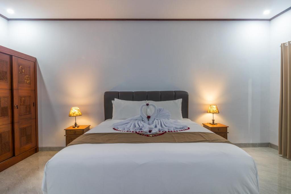 מיטה או מיטות בחדר ב-Amed Permai Home Stay
