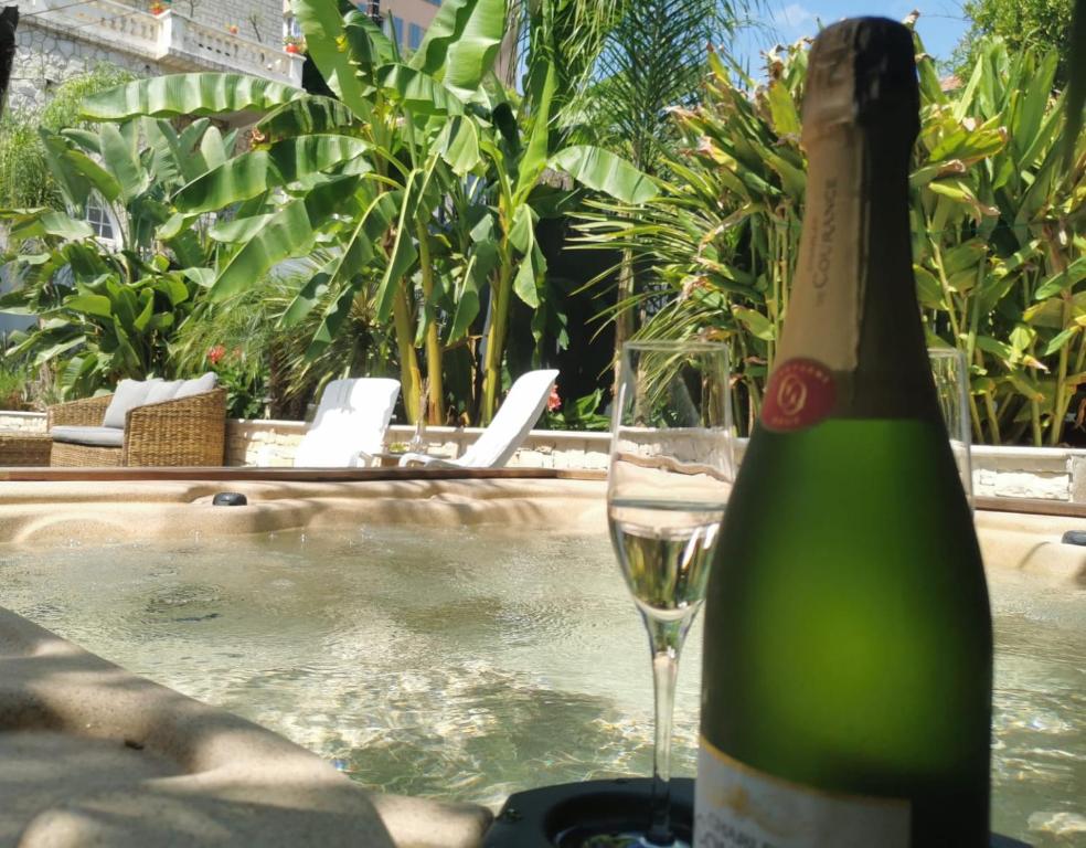 a bottle of champagne sitting next to a wine glass at La petite Niçoise au Jacuzzi à 3 min de la mer in Nice