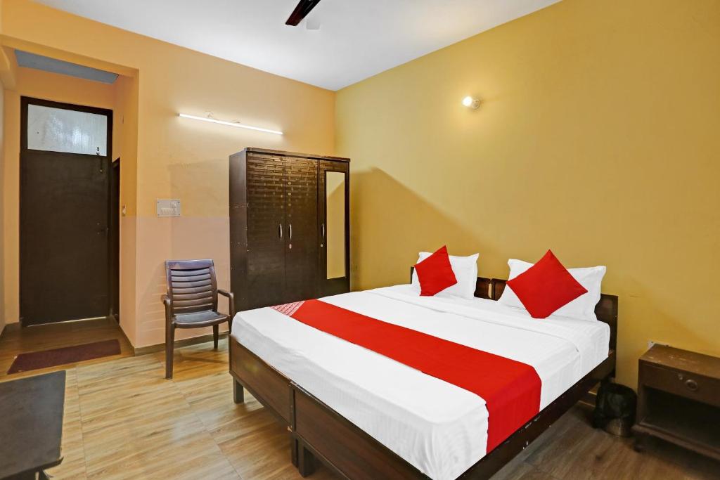 a bedroom with a bed and a chair in it at Super OYO Himani Residency Near Pvr Ansal Plaza Greater Noida in Greater Noida