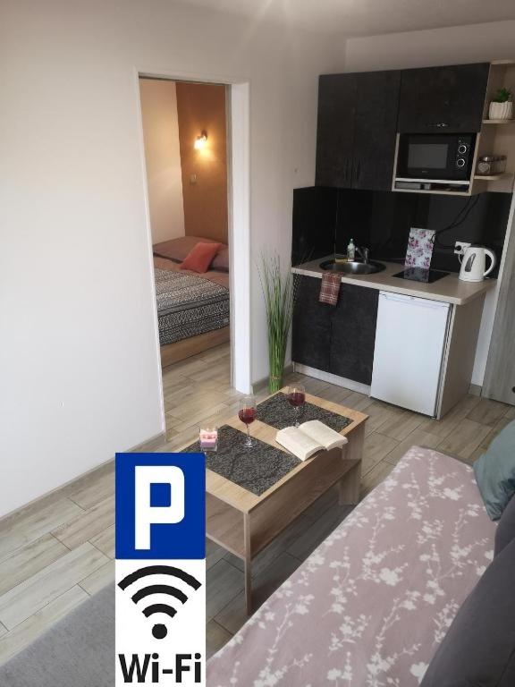 a small apartment with a kitchen and a living room at City Center Apartments - Apartamenty nad rzeką Nettą - Kilińskiego 22 in Augustów