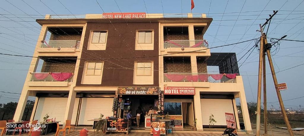 Un edificio alto con una tienda al lado. en Hotel The New Lake Palace, en Bhopal