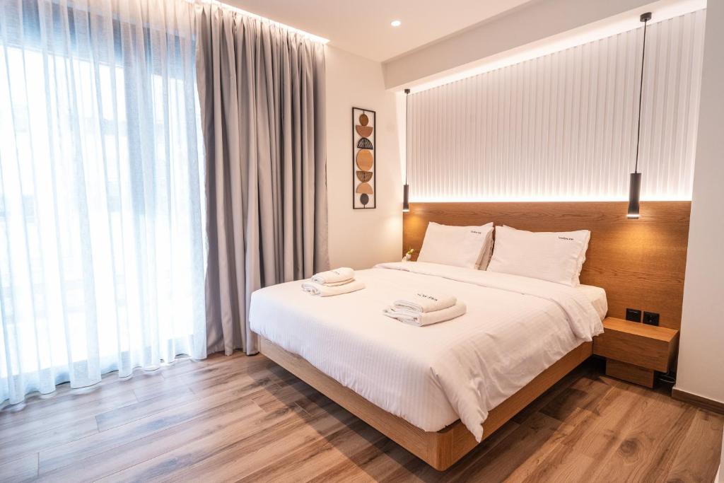 Postel nebo postele na pokoji v ubytování Volos Inn Hotel