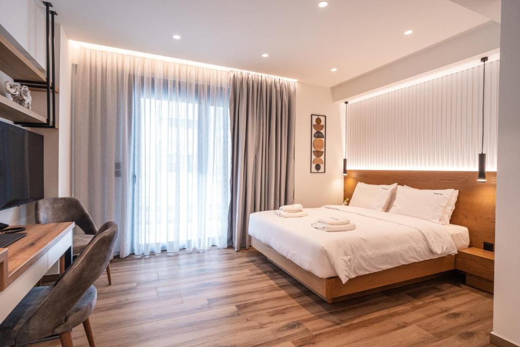 Postel nebo postele na pokoji v ubytování Volos Inn Hotel