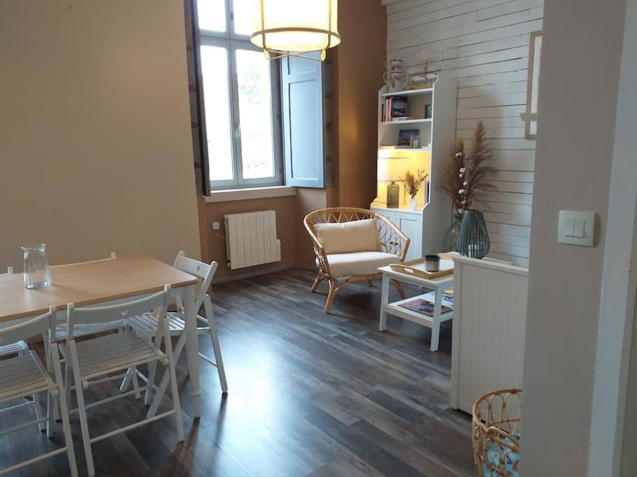 una sala de estar con una mesa y una silla en La Cabane du Roc, en Granville