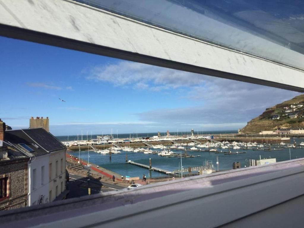 a view of a harbor from a window at Appartement à Fécamp avec vue port et mer Le Sémaphore in Fécamp