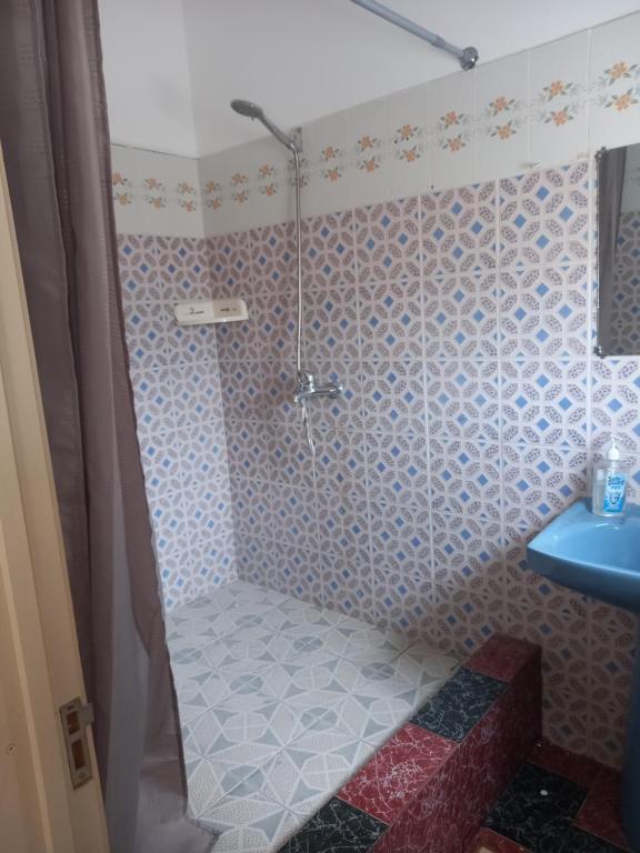 a bathroom with a shower and a blue sink at Tropical Retreats in Flic-en-Flac