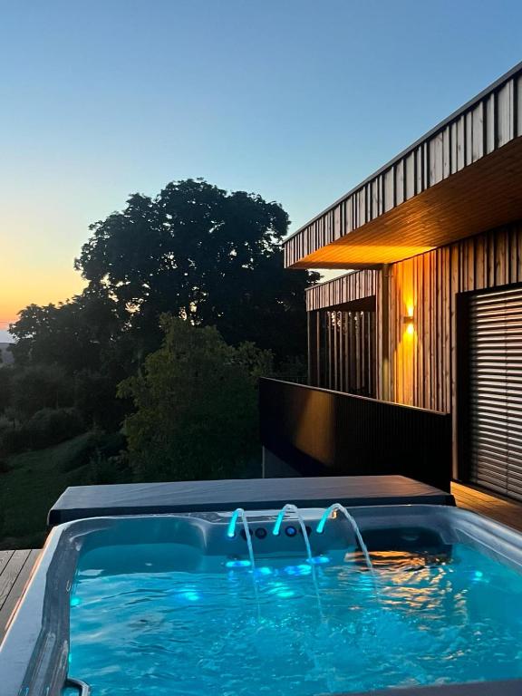 a swimming pool in front of a house at Ferienhaus LuckyLiving in Litzelsdorf