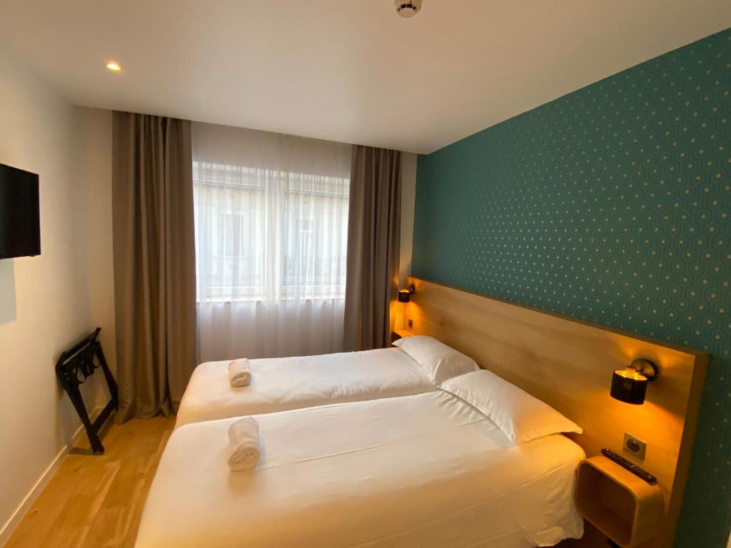 Postel nebo postele na pokoji v ubytování Oskar Hotel