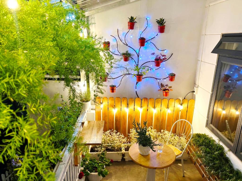 a patio with a table and some plants at Nhà Nhi Đà Lạt in Da Lat