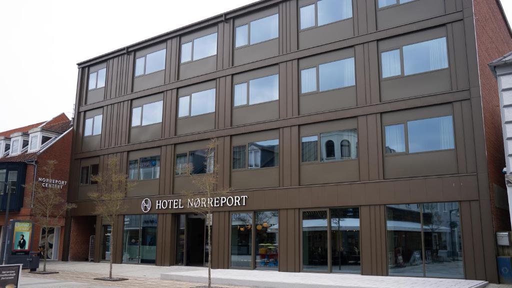 a large brown building with a sign on it at Hotel Nørreport in Holstebro