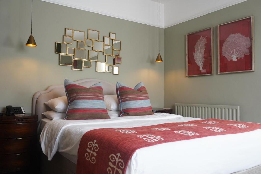 a bedroom with a bed with a red blanket and pillows at Tower Hotel in Lincoln